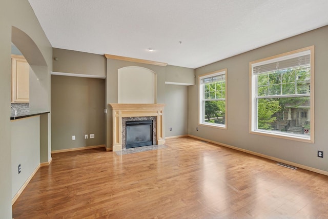 11350 Stratton Ave, Eden Prairie, MN 55344 - unfurnished living room with a high end fireplace and light wood-type flooring