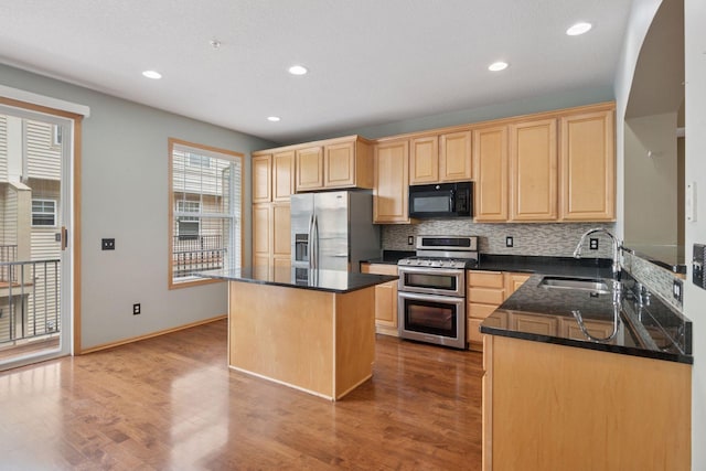 11350 Stratton Ave, Eden Prairie, MN 55344 - kitchen featuring appliances with stainless steel finishes, light brown cabinets, backsplash, a kitchen island, and wood finished floors