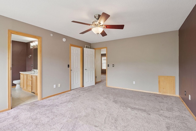 11350 Stratton Ave, Eden Prairie, MN 55344 - unfurnished bedroom featuring light carpet, connected bathroom, and ceiling fan