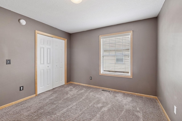 11350 Stratton Ave, Eden Prairie, MN 55344 - unfurnished bedroom with carpet, a closet, and a textured ceiling