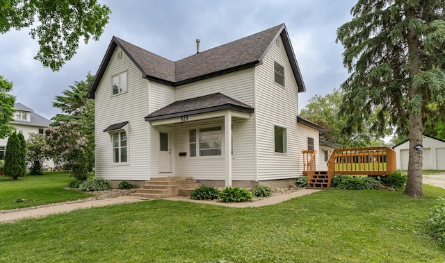 525 Warren Ave, Spring Valley, MN 55975 - traditional-style home featuring roof with shingles, a front yard, a deck, and a garage