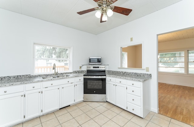 525 Warren Ave, Spring Valley, MN 55975 - kitchen featuring stainless steel appliances, white cabinets, a ceiling fan, light tile patterned floors, and light stone counters