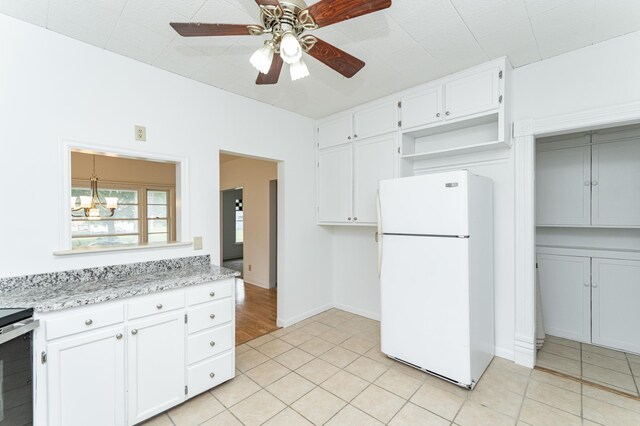 525 Warren Ave, Spring Valley, MN 55975 - kitchen with freestanding refrigerator, open shelves, light tile patterned floors, white cabinetry, and a ceiling fan
