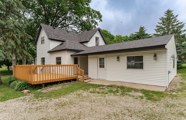 525 Warren Ave, Spring Valley, MN 55975 - rear view of house featuring a shingled roof and a wooden deck