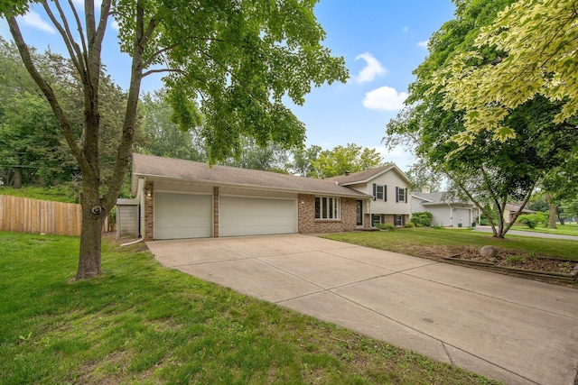 14136 Germane Ave, Apple Valley, MN 55124 - tri-level home with brick siding, a garage, and concrete driveway