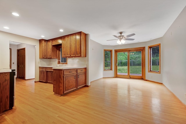 14136 Germane Ave, Apple Valley, MN 55124 - kitchen with light wood finished floors, brown cabinets, ceiling fan, light countertops, and recessed lighting