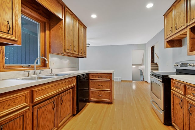 14136 Germane Ave, Apple Valley, MN 55124 - kitchen with stainless steel electric range, black dishwasher, light wood-type flooring, light countertops, and recessed lighting