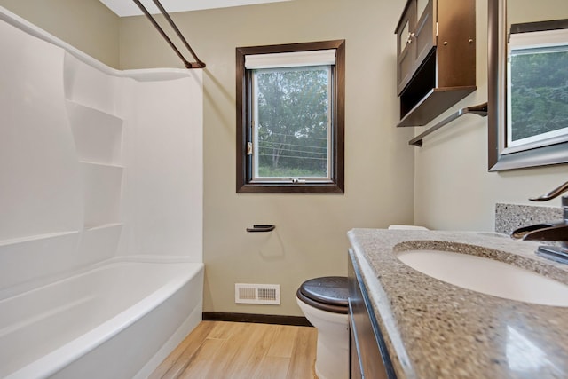 14136 Germane Ave, Apple Valley, MN 55124 - full bath with healthy amount of natural light, vanity, wood finished floors, and shower / bathtub combination