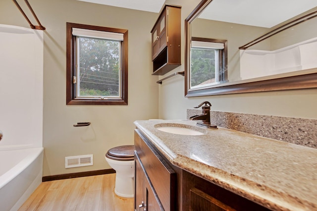 14136 Germane Ave, Apple Valley, MN 55124 - full bathroom with vanity, wood finished floors, and tub / shower combination