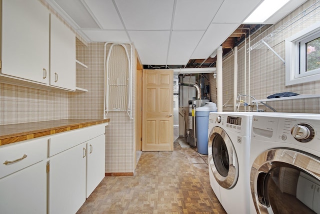 14136 Germane Ave, Apple Valley, MN 55124 - laundry area with washing machine and dryer, cabinet space, wallpapered walls, and gas water heater