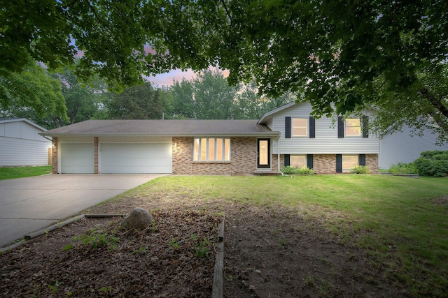 14136 Germane Ave, Apple Valley, MN 55124 - tri-level home with concrete driveway, an attached garage, a front lawn, and brick siding