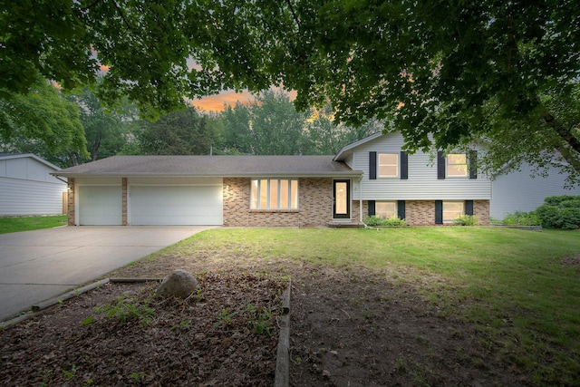 14136 Germane Ave, Apple Valley, MN 55124 - split level home featuring concrete driveway, a garage, a front yard, and brick siding