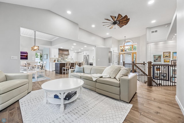 3020 26th Ave S, Fargo, ND 58103 - living room featuring light wood-type flooring, recessed lighting, a chandelier, lofted ceiling, and ceiling fan