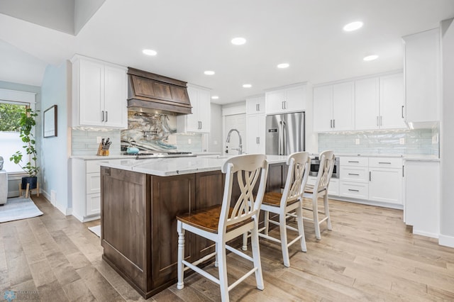 3020 26th Ave S, Fargo, ND 58103 - kitchen with stainless steel fridge with ice dispenser, custom exhaust hood, tasteful backsplash, white cabinetry, and recessed lighting