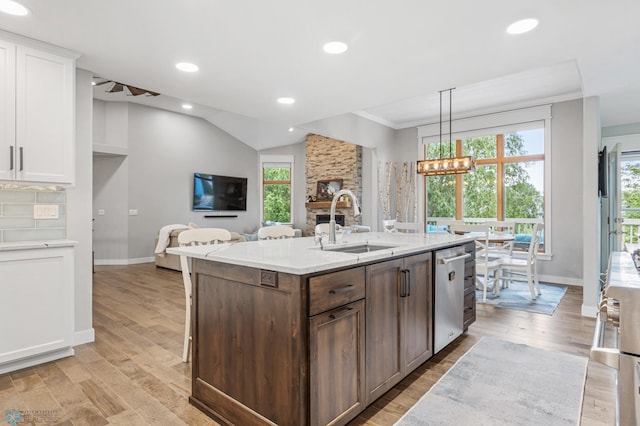 3020 26th Ave S, Fargo, ND 58103 - kitchen featuring stainless steel dishwasher, a chandelier, white cabinets, light wood-type flooring, and light stone countertops