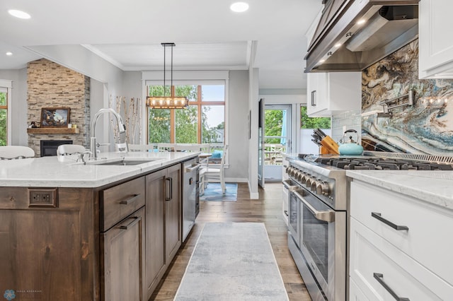 3020 26th Ave S, Fargo, ND 58103 - kitchen with appliances with stainless steel finishes, custom range hood, white cabinets, backsplash, and recessed lighting