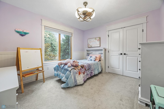 3020 26th Ave S, Fargo, ND 58103 - carpeted bedroom featuring a wainscoted wall, a closet, and a chandelier