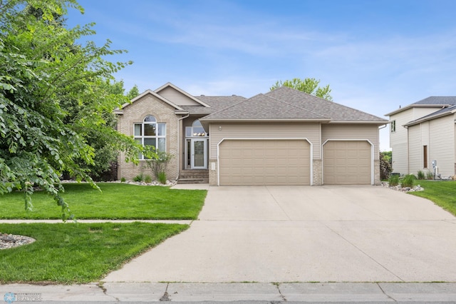 3020 26th Ave S, Fargo, ND 58103 - single story home with brick siding, an attached garage, concrete driveway, a front lawn, and a shingled roof