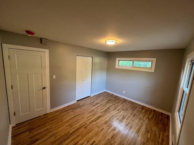 5923 Hodgson Rd, Shoreview, MN 55126 - unfurnished bedroom featuring wood finished floors and a closet