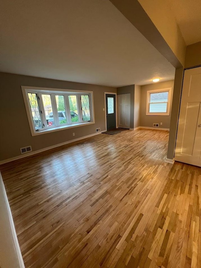 5923 Hodgson Rd, Shoreview, MN 55126 - unfurnished living room featuring light wood-style flooring and baseboards