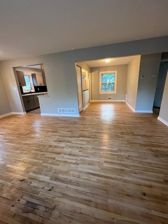 5923 Hodgson Rd, Shoreview, MN 55126 - unfurnished living room featuring wood finished floors and baseboards