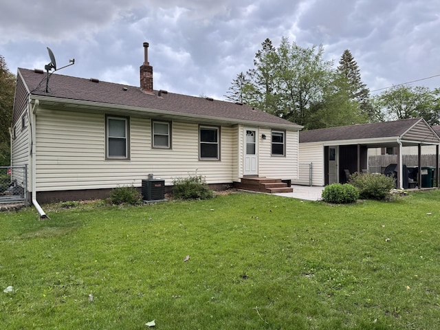 5923 Hodgson Rd, Shoreview, MN 55126 - back of property with a chimney, a lawn, and roof with shingles