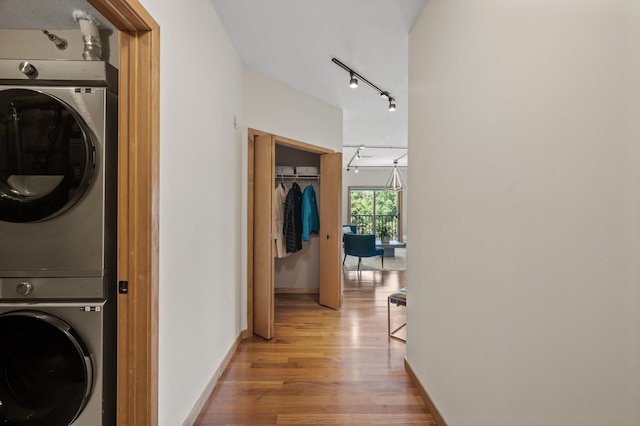 3000 Raleigh Ave Unit 307, Saint Louis Park, MN 55416 - washroom featuring stacked washer / dryer, light wood finished floors, and track lighting