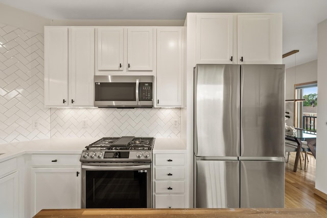 3000 Raleigh Ave Unit 307, Saint Louis Park, MN 55416 - kitchen featuring stainless steel appliances, decorative backsplash, light countertops, and white cabinetry