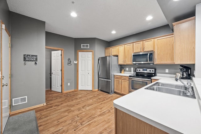 11122 Aberdeen St NE Unit C, Blaine, MN 55449 - kitchen with appliances with stainless steel finishes, light brown cabinetry, light wood-type flooring, light countertops, and recessed lighting