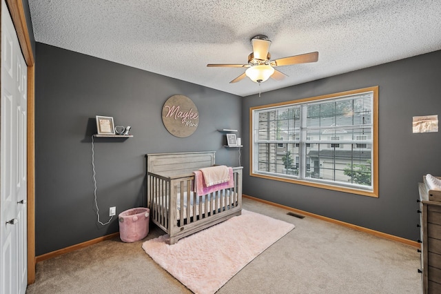 11122 Aberdeen St NE Unit C, Blaine, MN 55449 - bedroom featuring carpet, a nursery area, a ceiling fan, a textured ceiling, and a closet