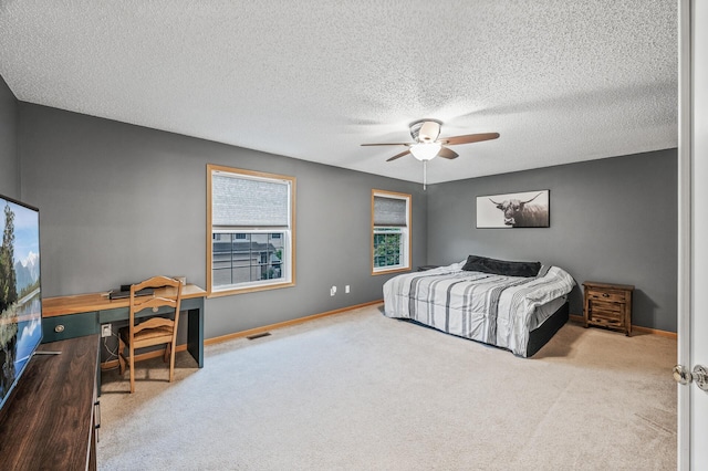 11122 Aberdeen St NE Unit C, Blaine, MN 55449 - carpeted bedroom with an office area, a textured ceiling, and ceiling fan