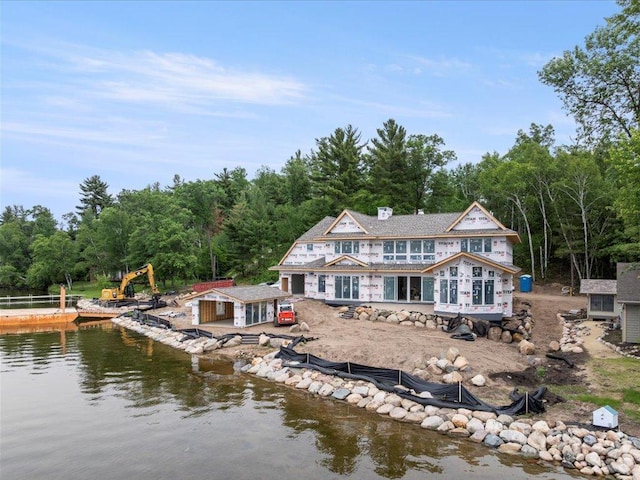 11251 Steamboat Bay Dr, East Gull Lake, MN 56401 - rear view of house featuring a water view, a wooded view, an outdoor structure, and a patio