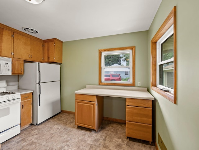 7920 Clinton Ave S, Bloomington, MN 55420 - kitchen with white appliances, built in study area, brown cabinets, and light countertops
