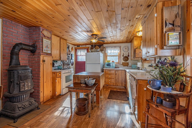 2170 County 5 NW, Hackensack, MN 56452 - kitchen featuring white appliances, light wood-style floors, light countertops, a wood stove, and wood ceiling