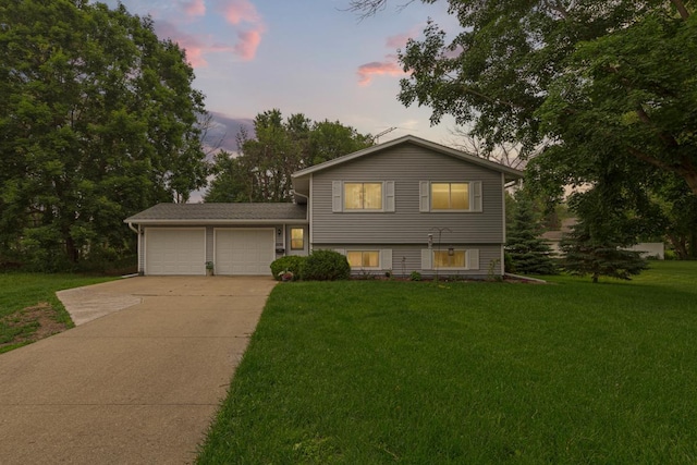1030 Barron Rd, Faribault, MN 55021 - tri-level home with concrete driveway, a front yard, and a garage