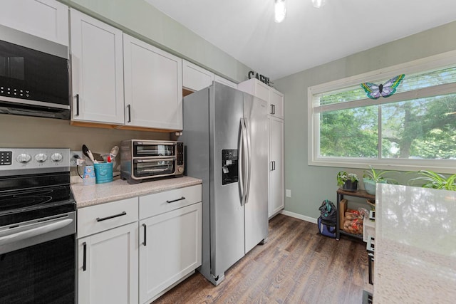 1030 Barron Rd, Faribault, MN 55021 - kitchen featuring appliances with stainless steel finishes, white cabinets, and light wood finished floors