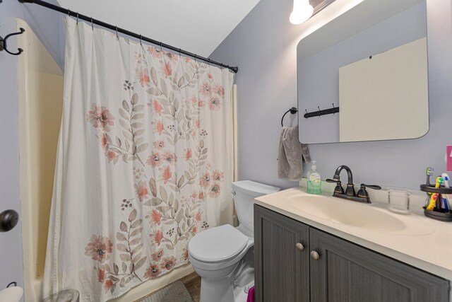 1030 Barron Rd, Faribault, MN 55021 - full bathroom featuring vanity, shower / bath combo, and wood finished floors