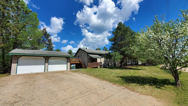 16029 71st Ave NW, Cass Lake, MN 56633 - view of front facade featuring a front lawn, a deck, and a detached garage