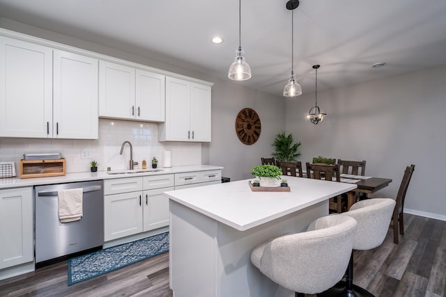 422 Ford St E, Northfield, MN 55057 - kitchen featuring dishwasher, dark wood-type flooring, tasteful backsplash, light countertops, and a kitchen island