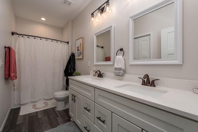 422 Ford St E, Northfield, MN 55057 - full bath with wood finished floors, double vanity, recessed lighting, and shower / bath combination with curtain