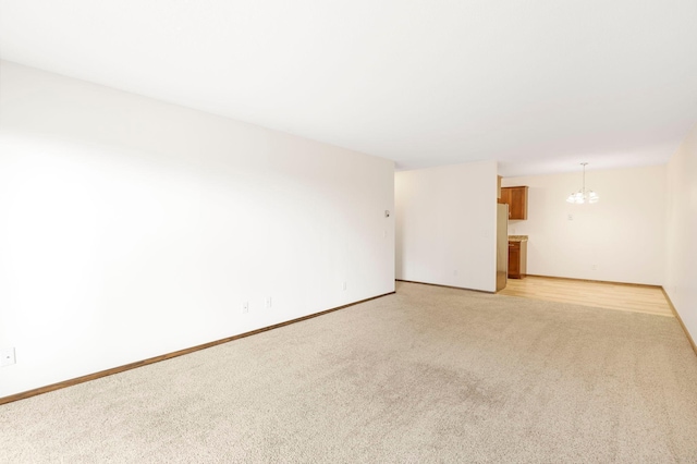 205 Barry Ave S Unit 208, Wayzata, MN 55391 - unfurnished room with light carpet and a chandelier