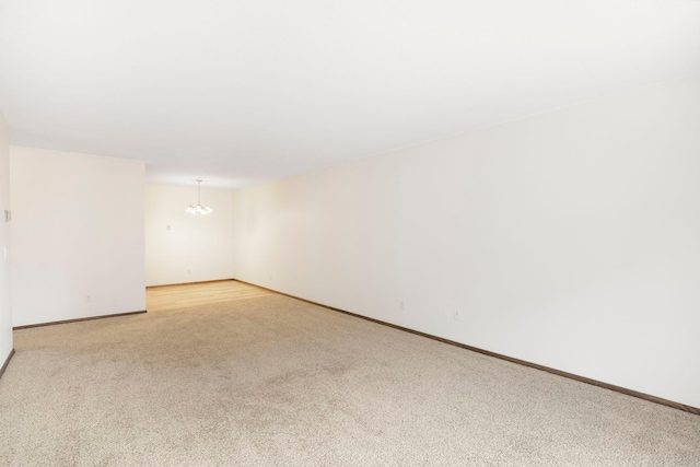 205 Barry Ave S Unit 208, Wayzata, MN 55391 - empty room featuring a chandelier and light carpet