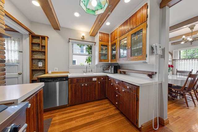 825 5th Ave SW, Faribault, MN 55021 - kitchen featuring dishwasher, beam ceiling, light wood finished floors, light countertops, and glass insert cabinets