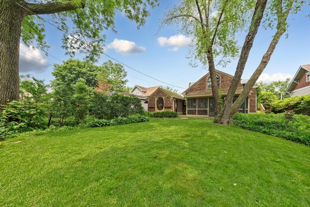825 5th Ave SW, Faribault, MN 55021 - view of grassy yard featuring a sunroom