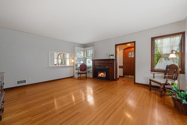 825 5th Ave SW, Faribault, MN 55021 - unfurnished living room with light wood-type flooring and a fireplace with flush hearth