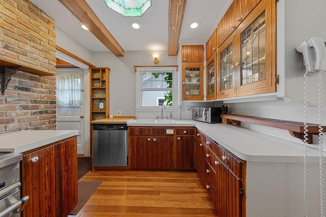 825 5th Ave SW, Faribault, MN 55021 - kitchen with stainless steel appliances, light wood-style floors, light countertops, glass insert cabinets, and a skylight