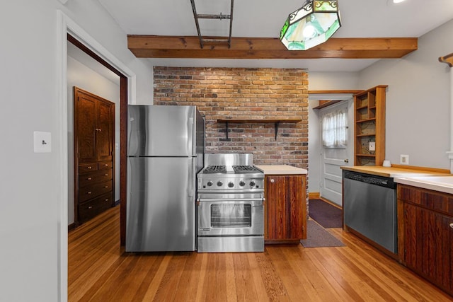 825 5th Ave SW, Faribault, MN 55021 - kitchen featuring appliances with stainless steel finishes, beam ceiling, light wood finished floors, light countertops, and open shelves