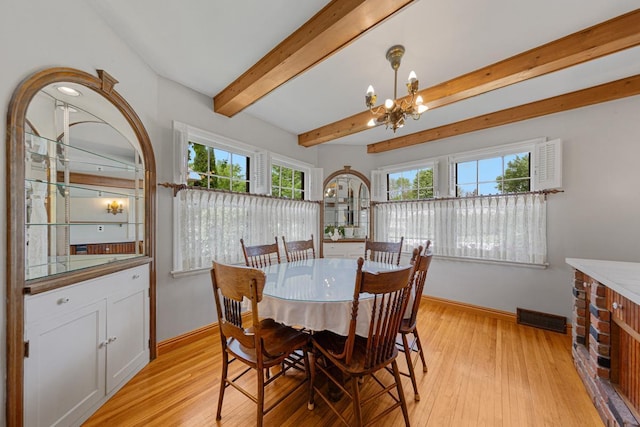 825 5th Ave SW, Faribault, MN 55021 - dining room featuring a chandelier, light wood-style floors, and beamed ceiling