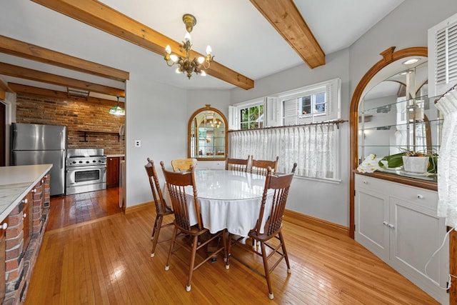 825 5th Ave SW, Faribault, MN 55021 - dining area featuring a chandelier, light wood-style flooring, and beam ceiling
