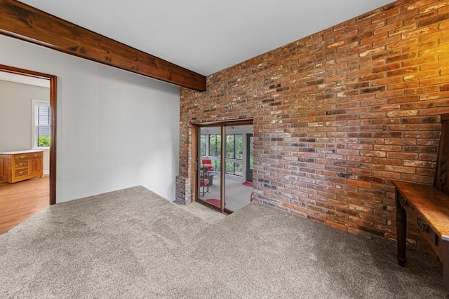 825 5th Ave SW, Faribault, MN 55021 - carpeted spare room with brick wall and beamed ceiling